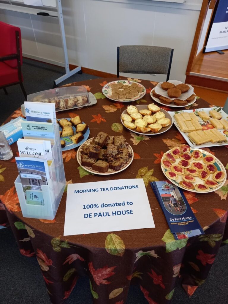 Plates of morning tea food, brochures and a sign saying all donations to De Paul House.