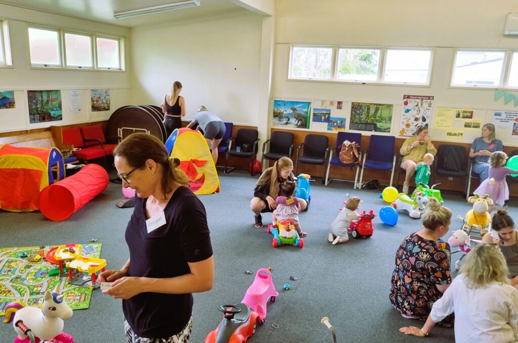 Adults and children playing with the toys at mainly music