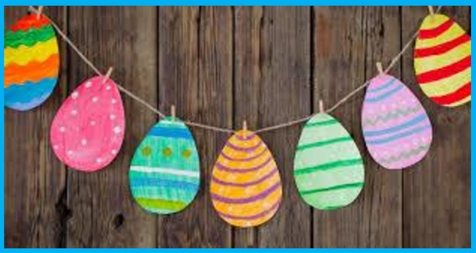 A garland of brightly coloured cardboard Easter egg shapes.