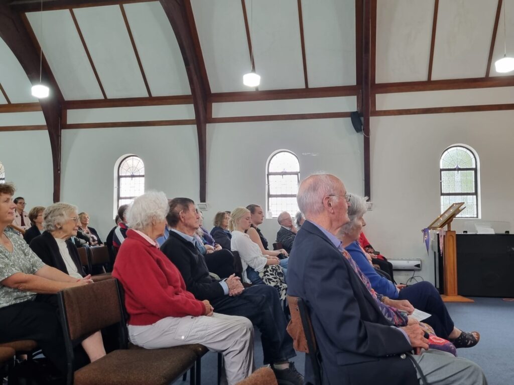 People sitting in church listening intently.