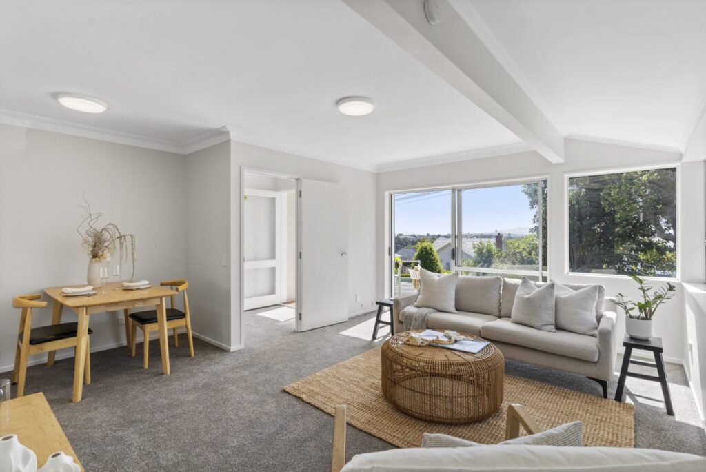 Lounge and dining area. View to trees and Rangitoto.