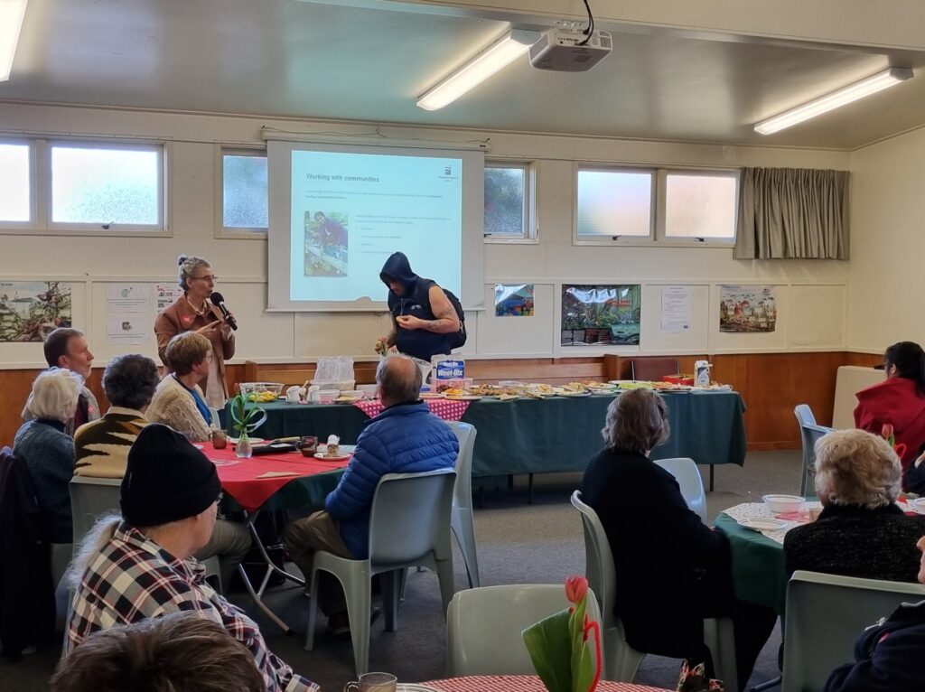 Bonnie talks over breakfast to a room of people.