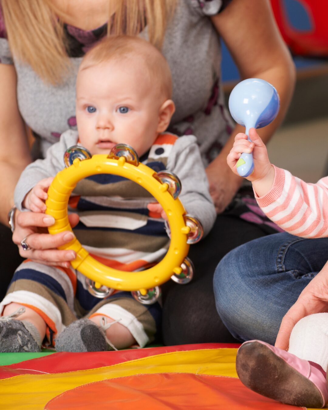Baby holding a musical instrument